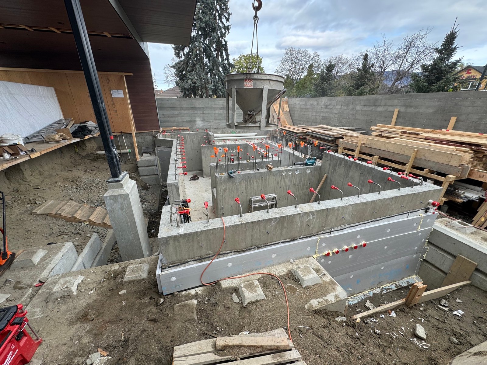 Freshly finished stamped concrete patio with retaining wall