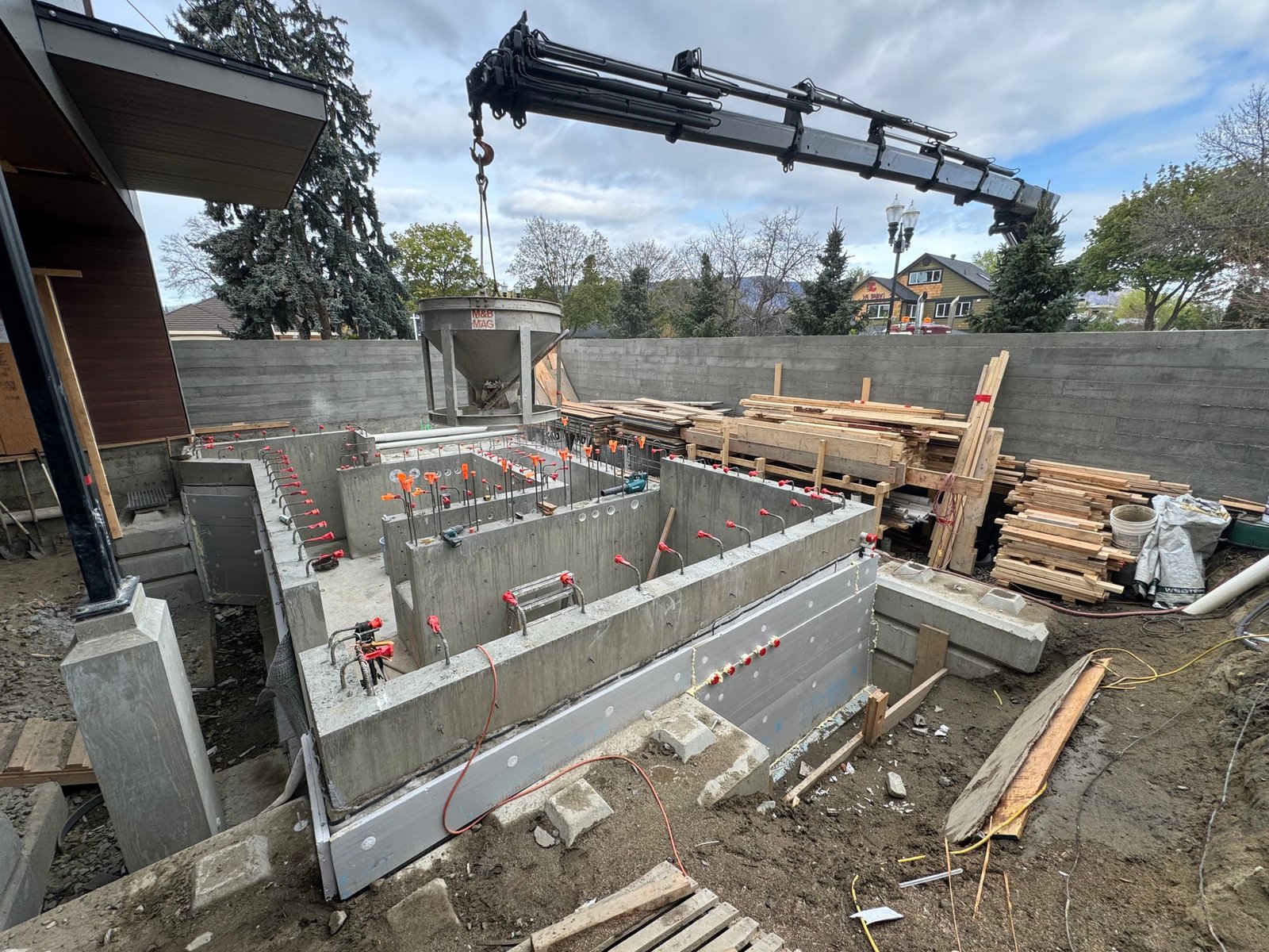 Concrete pour with crane during a structural pool build