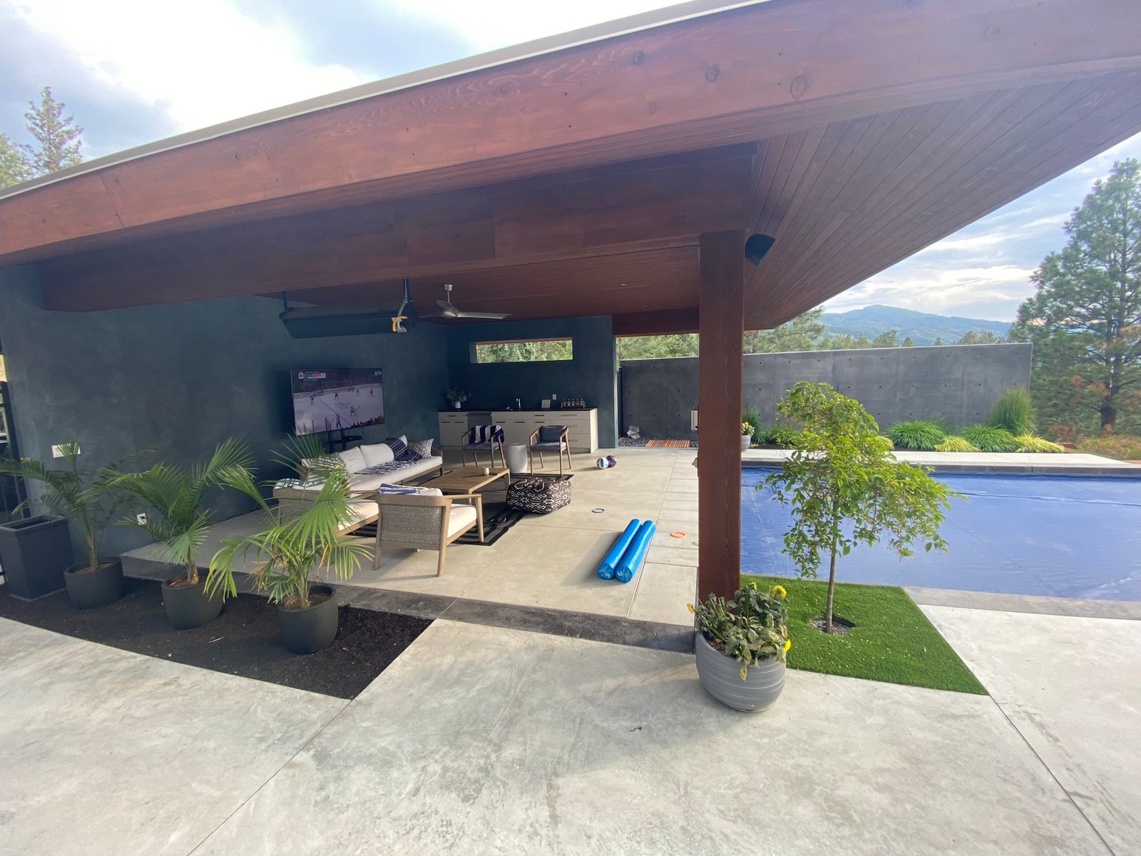 Poolside pavilion with outdoor lounge and TV